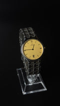 Omega – złota tarcza, cyfry rzymskie, datownik, srebrna bransoleta